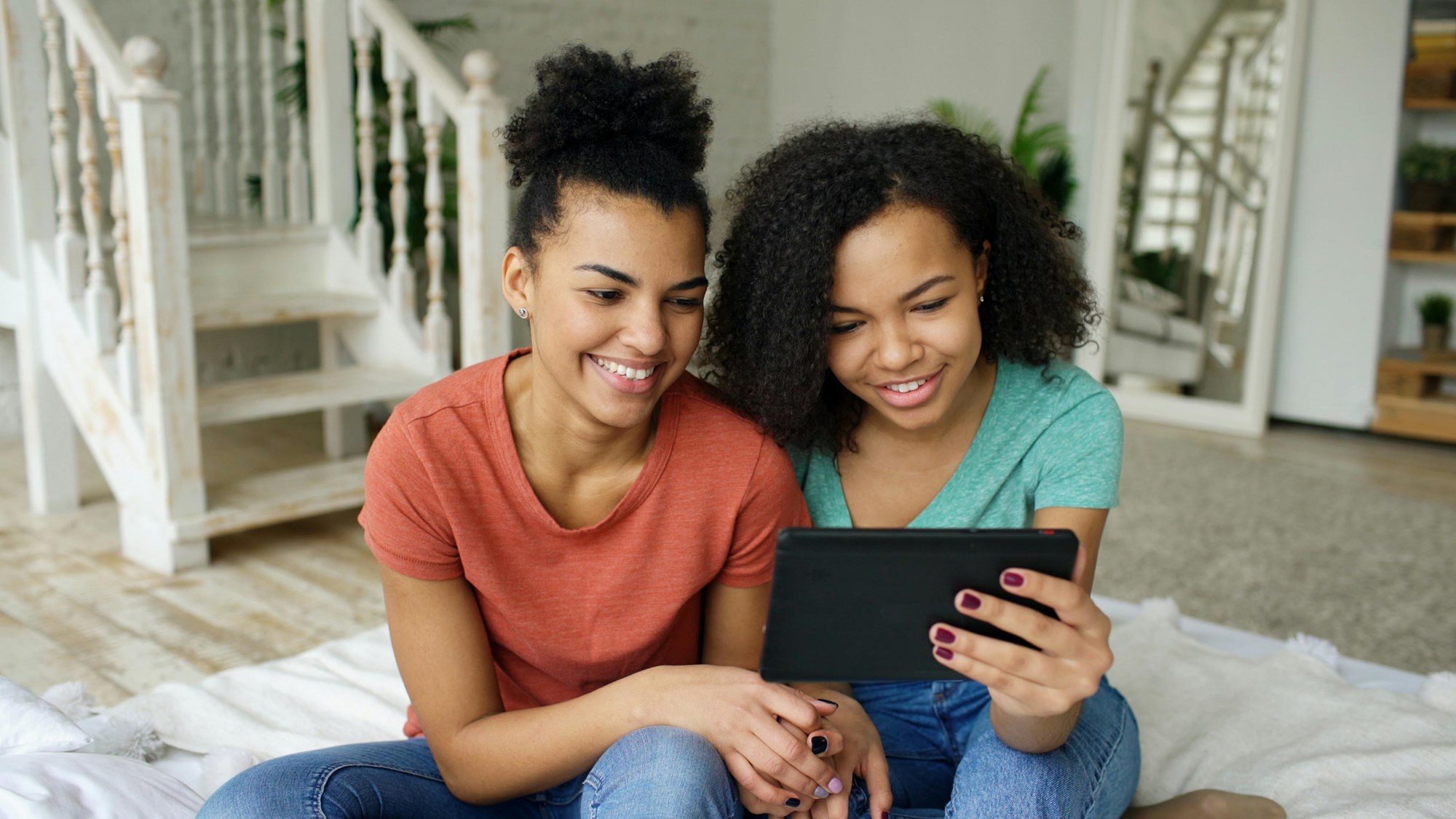 Two Young Women Enjoying a Digital Tablet