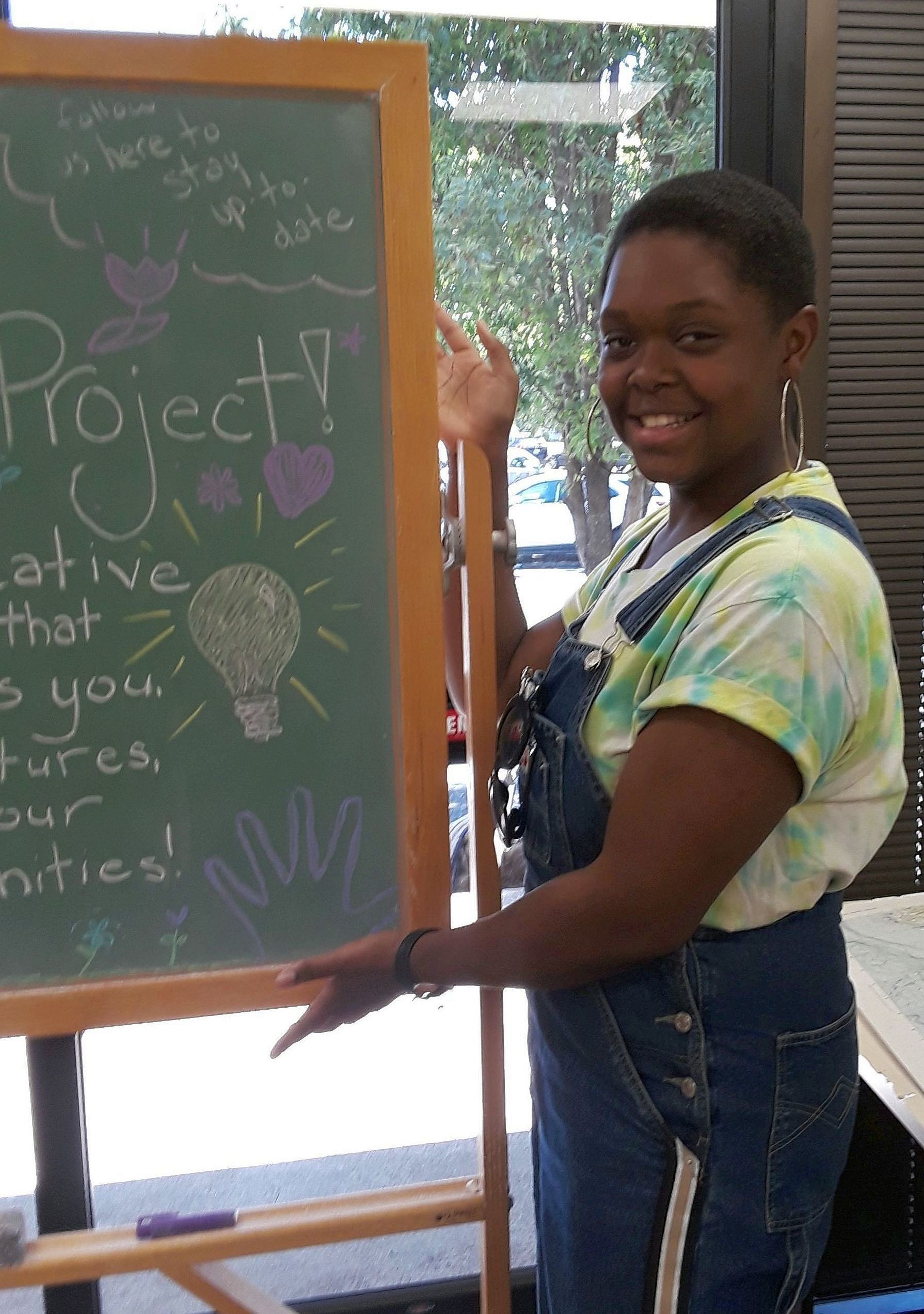 Cortunay Minor in front of a chalkboard