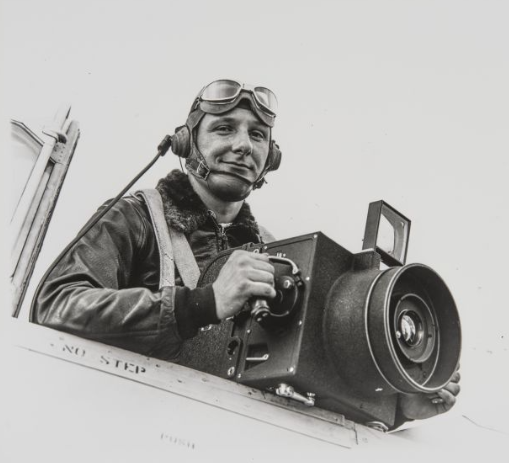 Sonoma County photographer Don Meacham on board of his plane holding a camera.