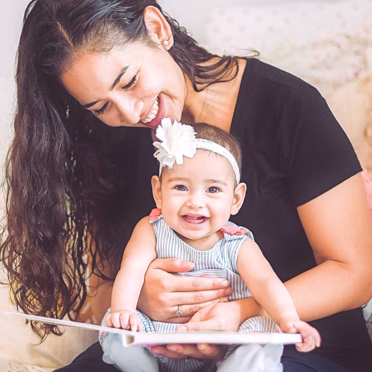 mom reading to infant daughter