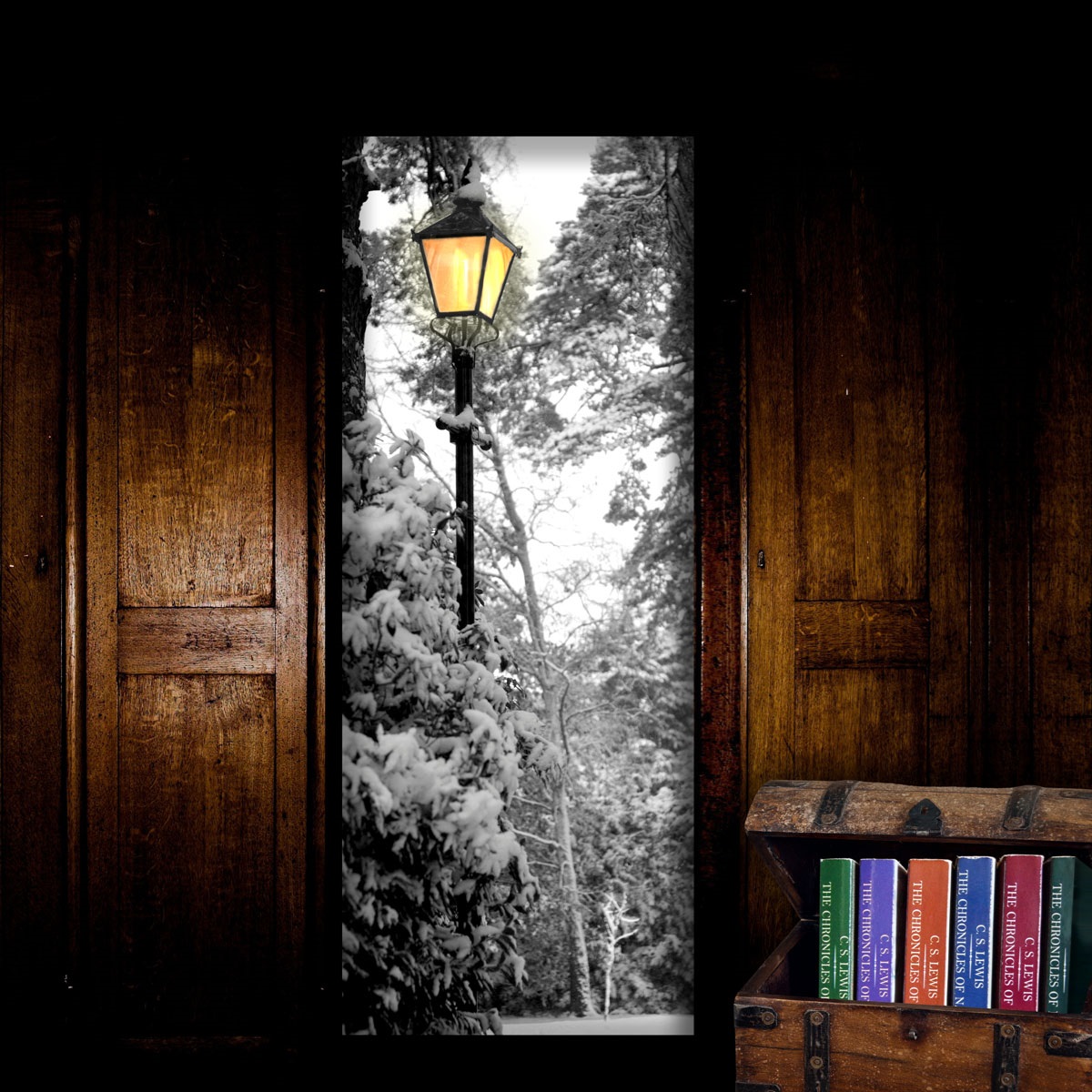 A wardrobe with its door open showing an opening to Narnia inside, and a trunk full of the Chronicles of Narnia books.