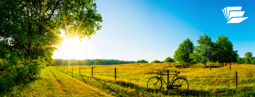 Community Library Network, Image of a field at sunset with a bicycle leaning against a rural fence in the foreground. Link to external site, opens in a new tab or window.