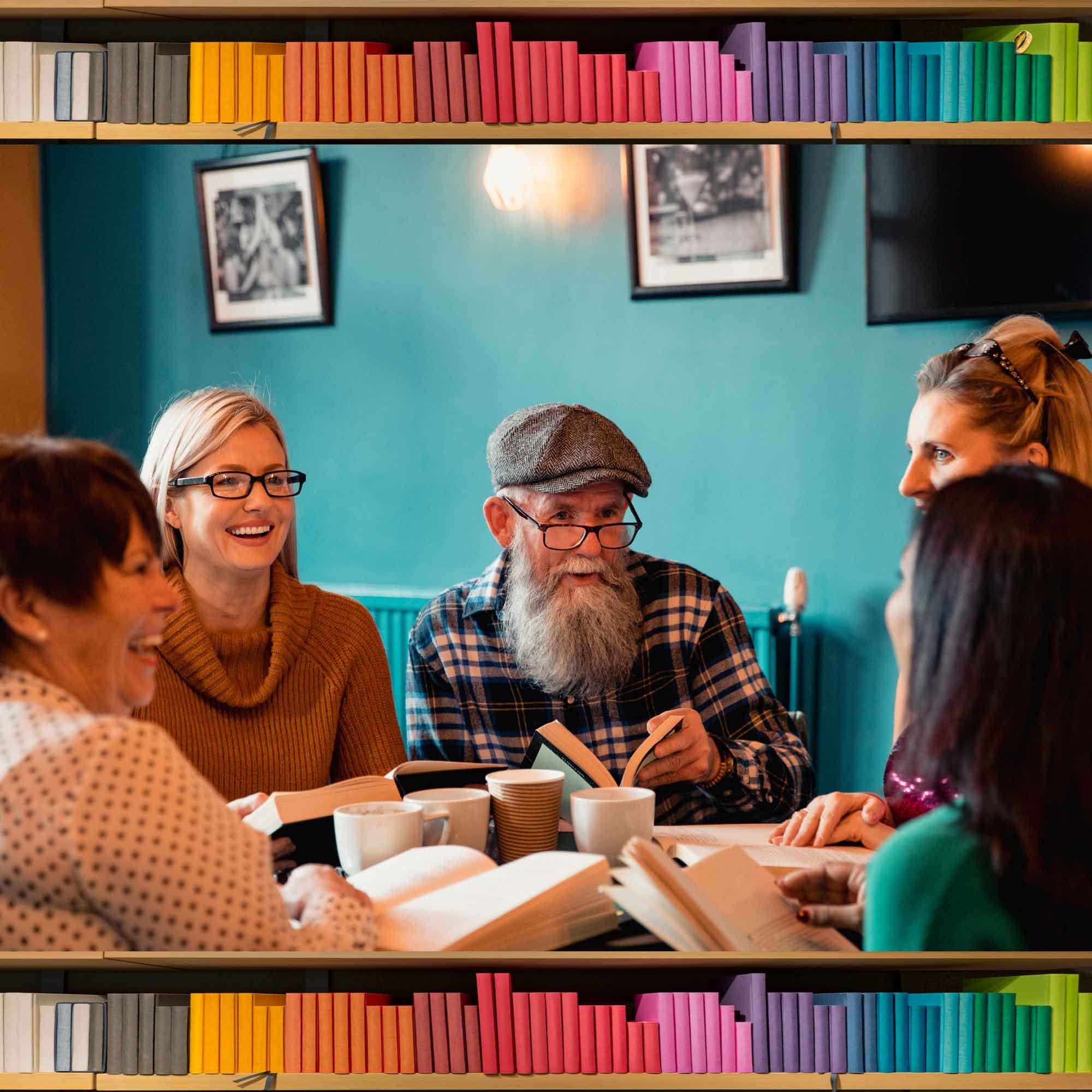 Image links to website calendar.  Image shows various people gathered around a table with books.