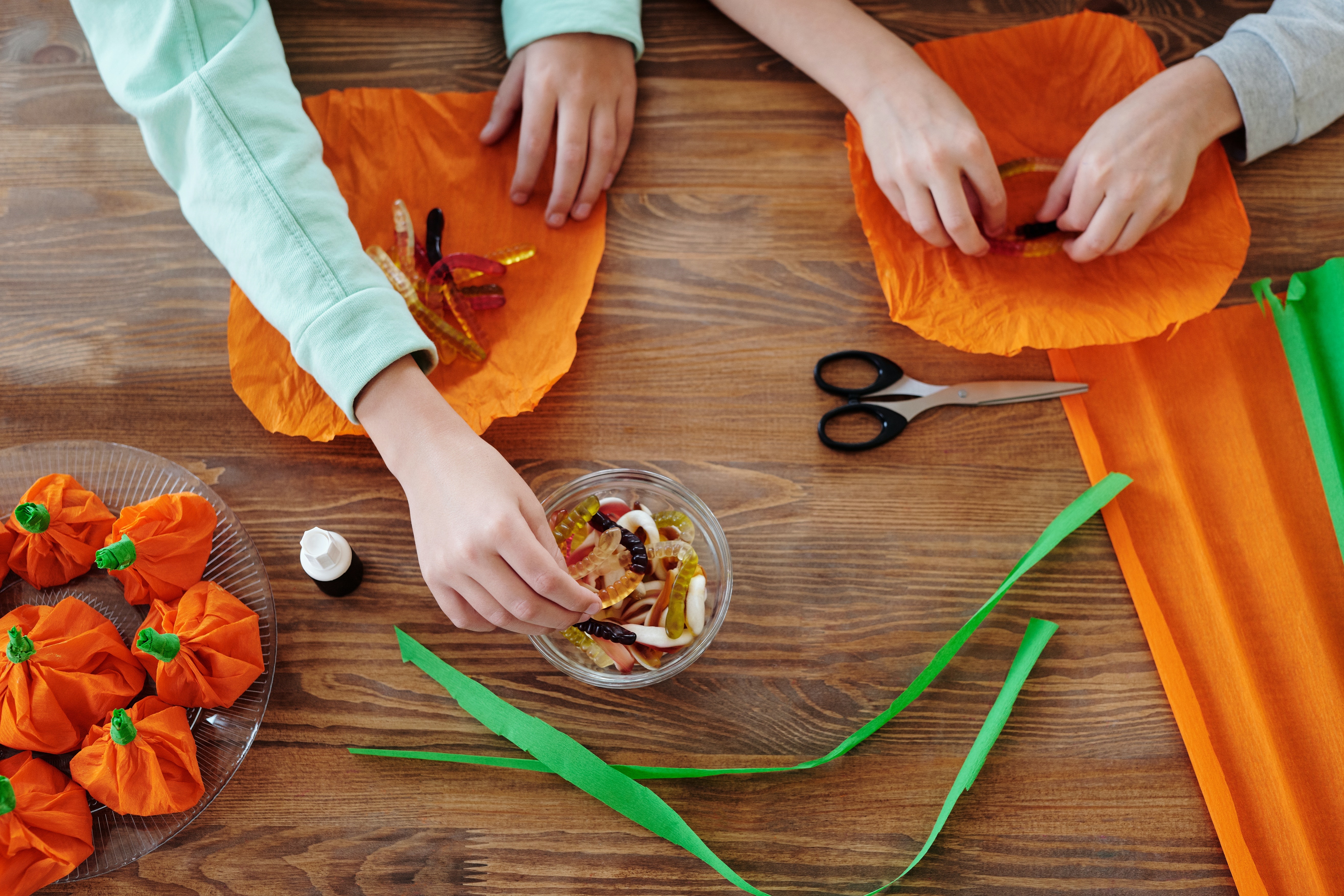 two people making pumpkin crafts