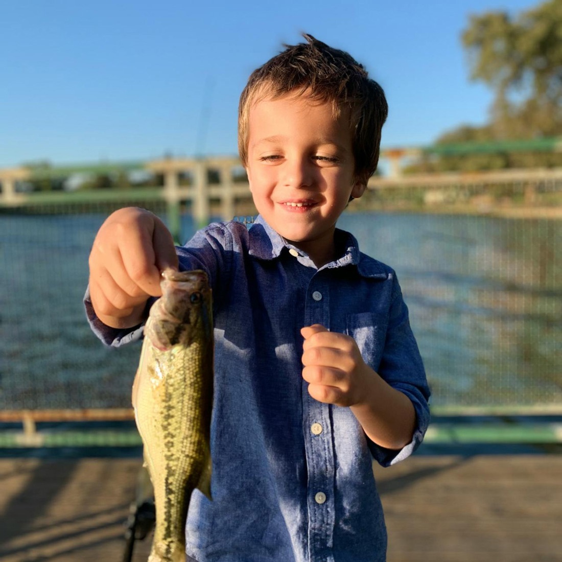 A proud and happy little boy, holding the fish he just caught during Free Fishing Day.