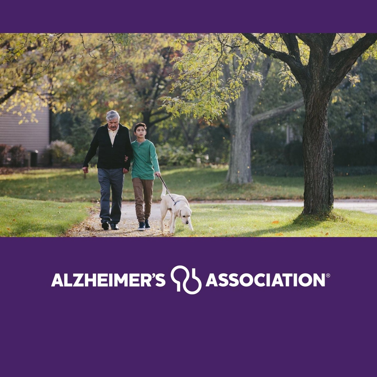 A young man, walking with his grandfather and his dog, on a beautiful day, and the Alzheimer's Association logo.