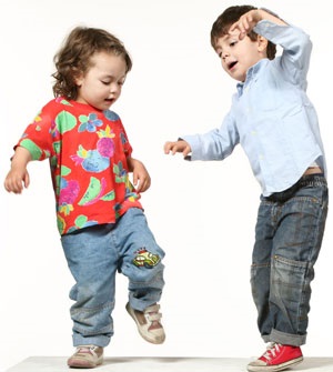 Two toddlers dancing and playing.