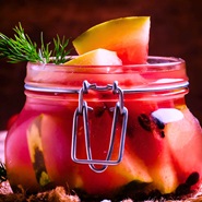 Image is of a small jar of pickled watermelon.