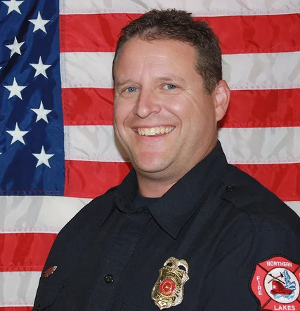 Deputy Fire Marshall with American flag in the background