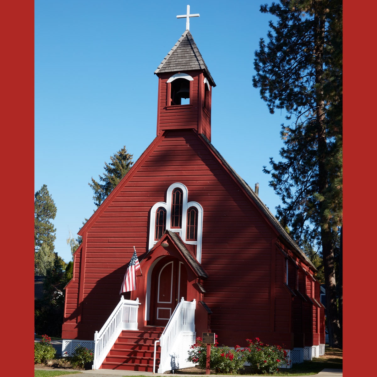 Image is a photo of Fort Sherman --it is painted red and white and looks reminiscent of an old chapel.