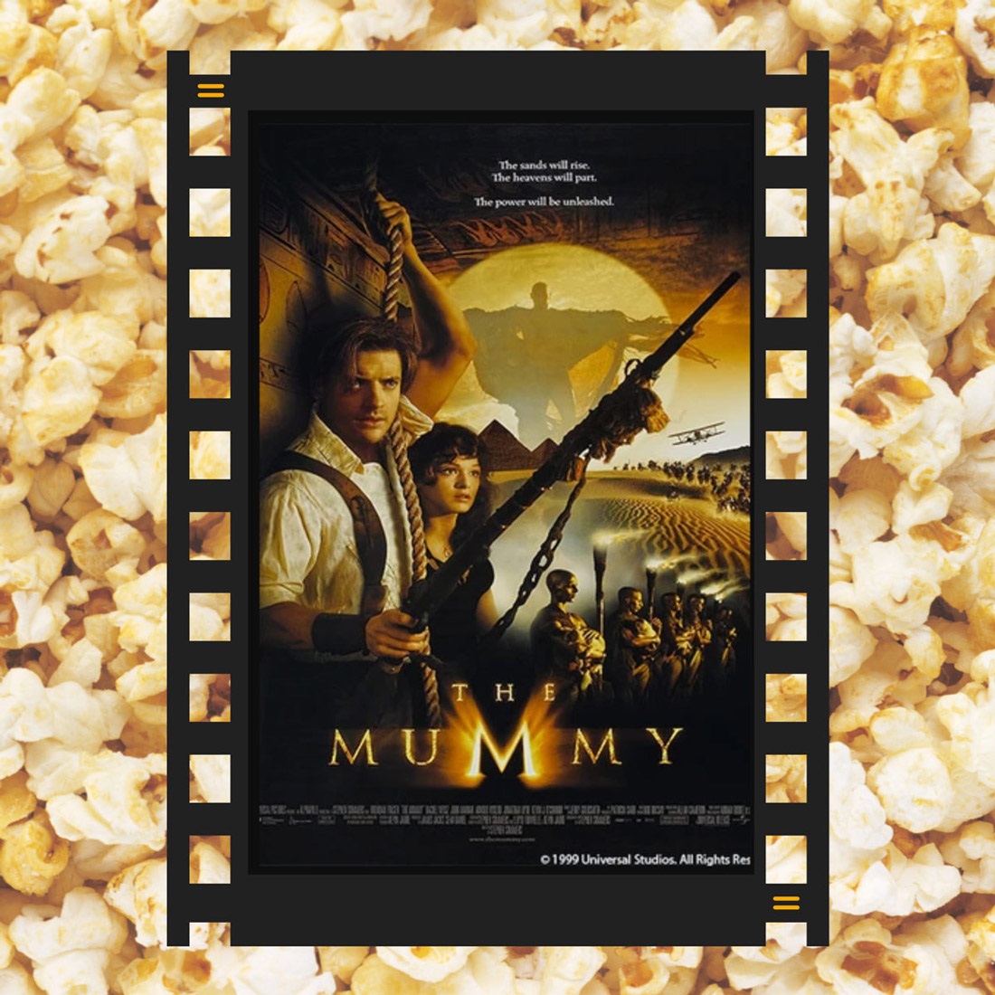 A piece of film reel with The Mummy DVD cover and popcorn in the background.
