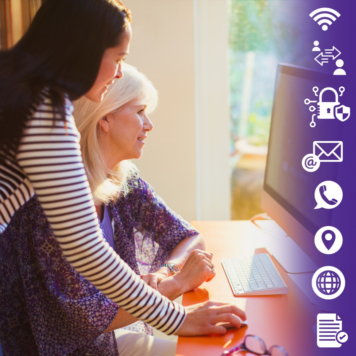 Woman helping another woman on a computer.