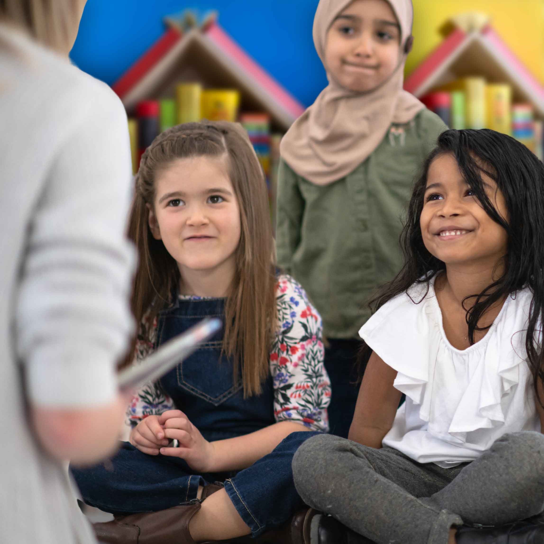 Kids excited to hear a story read to them. This linked image will take you to a calendar event in an external site and in a new tab or window.