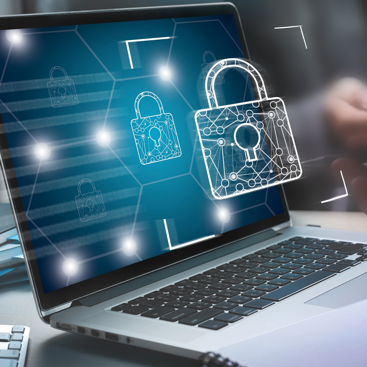 Image shows a laptop with the image of a padlock superimposed in glowing white.