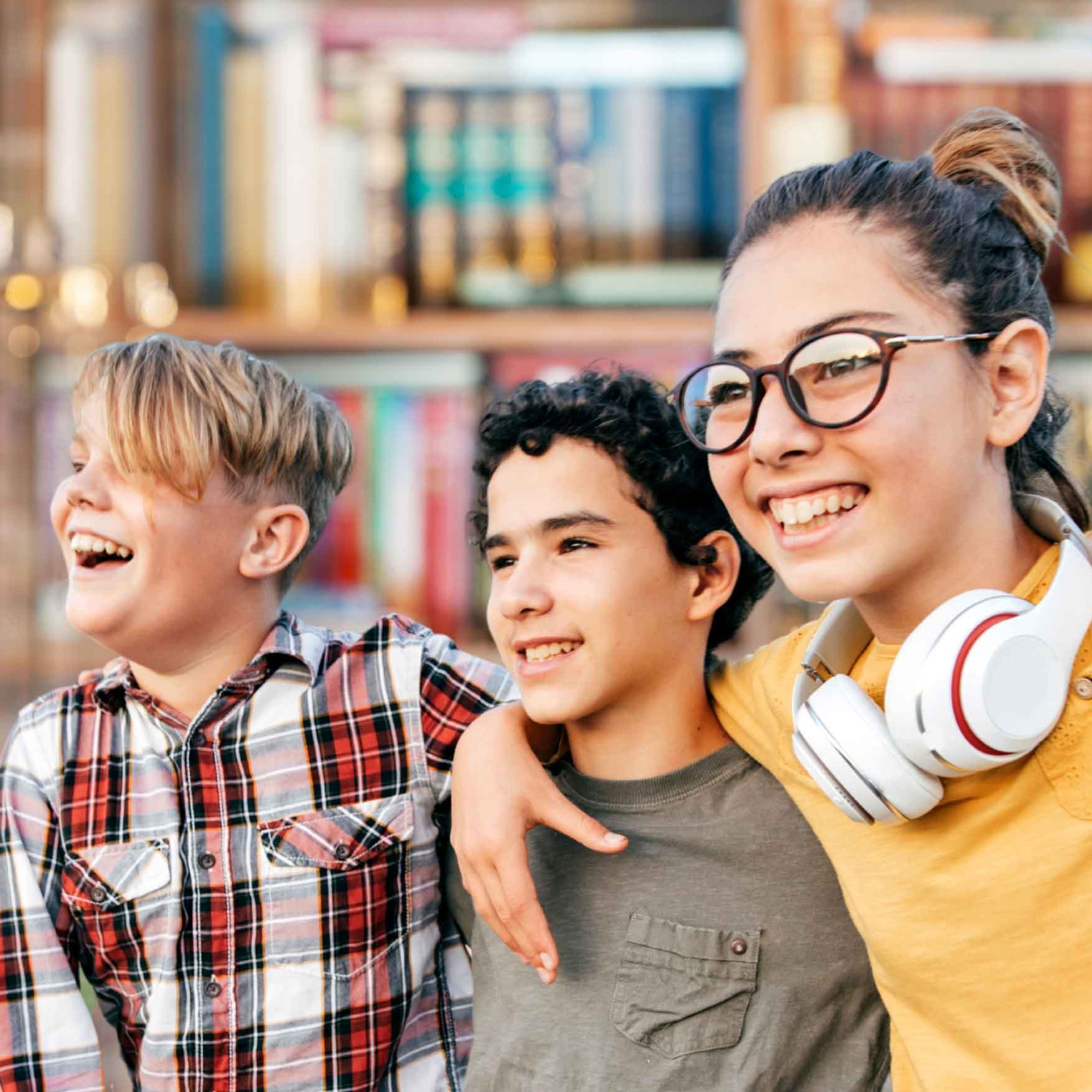 three middle school students smiling and looking into the distance