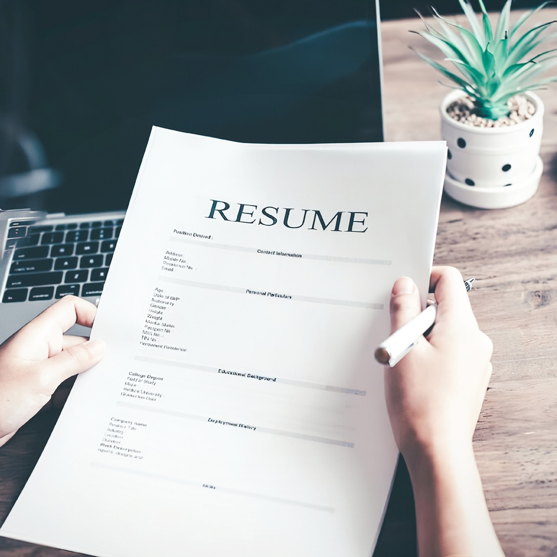 Person holding a resume.