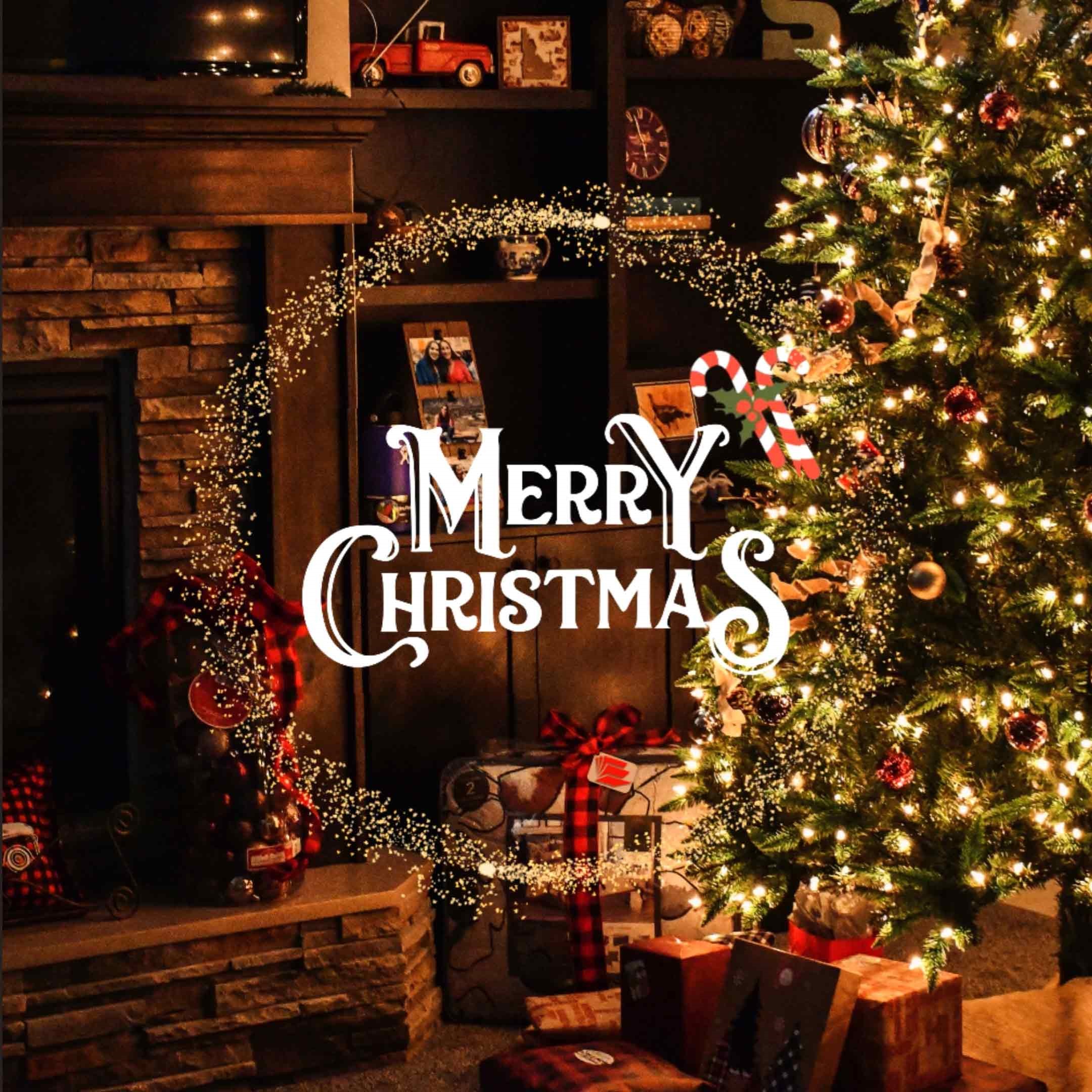 Pictures shows a cozy christmas scene with a partial brick fireplace on one side and a lit christmas tree with presents on the other.  In the center the words read: Merry Christmas.