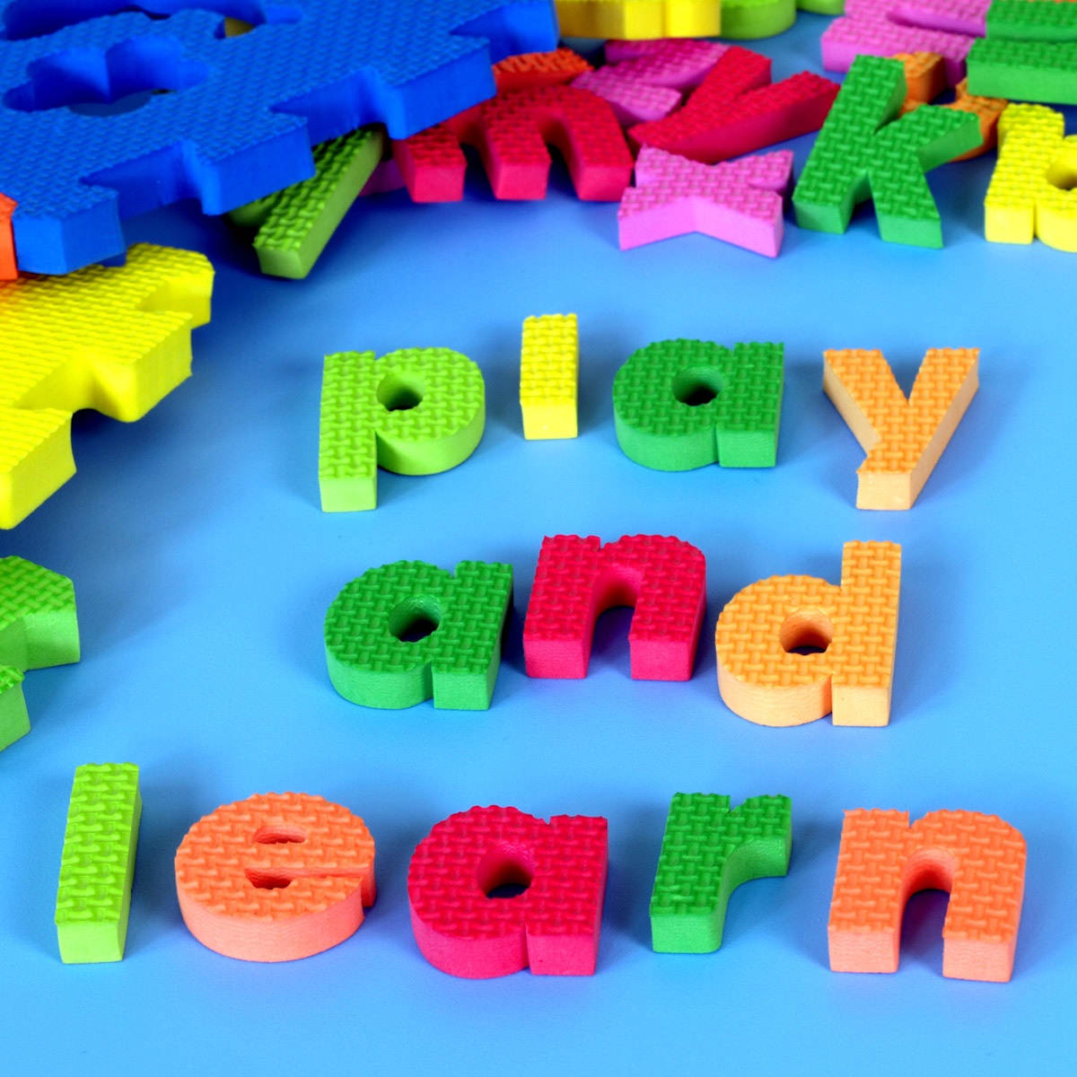 Play and Learn spelled out in foam letters