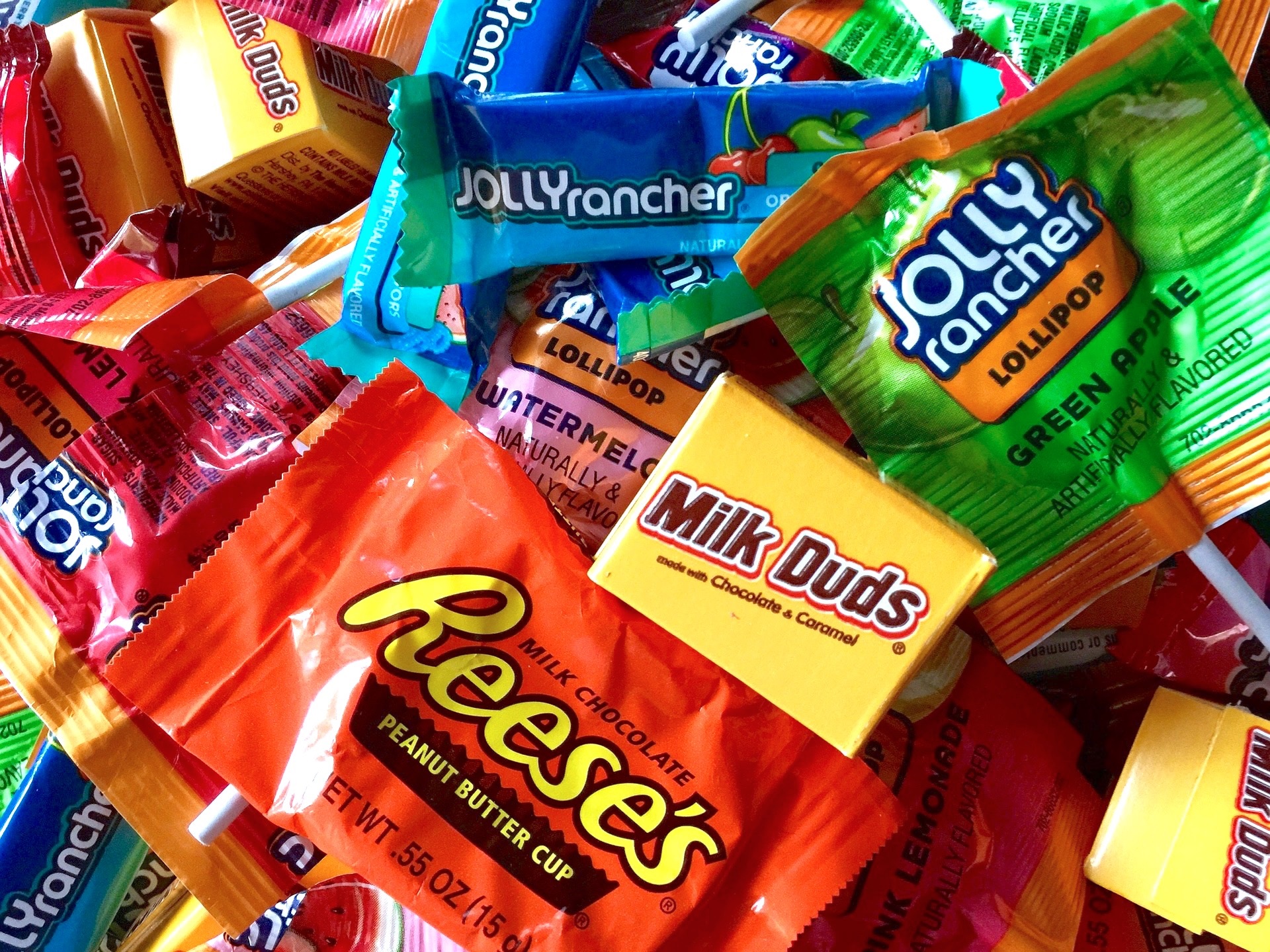 Image of candy wrappers including Jolly Ranchers, Milk Duds, and Reese Peanut Butter Cups