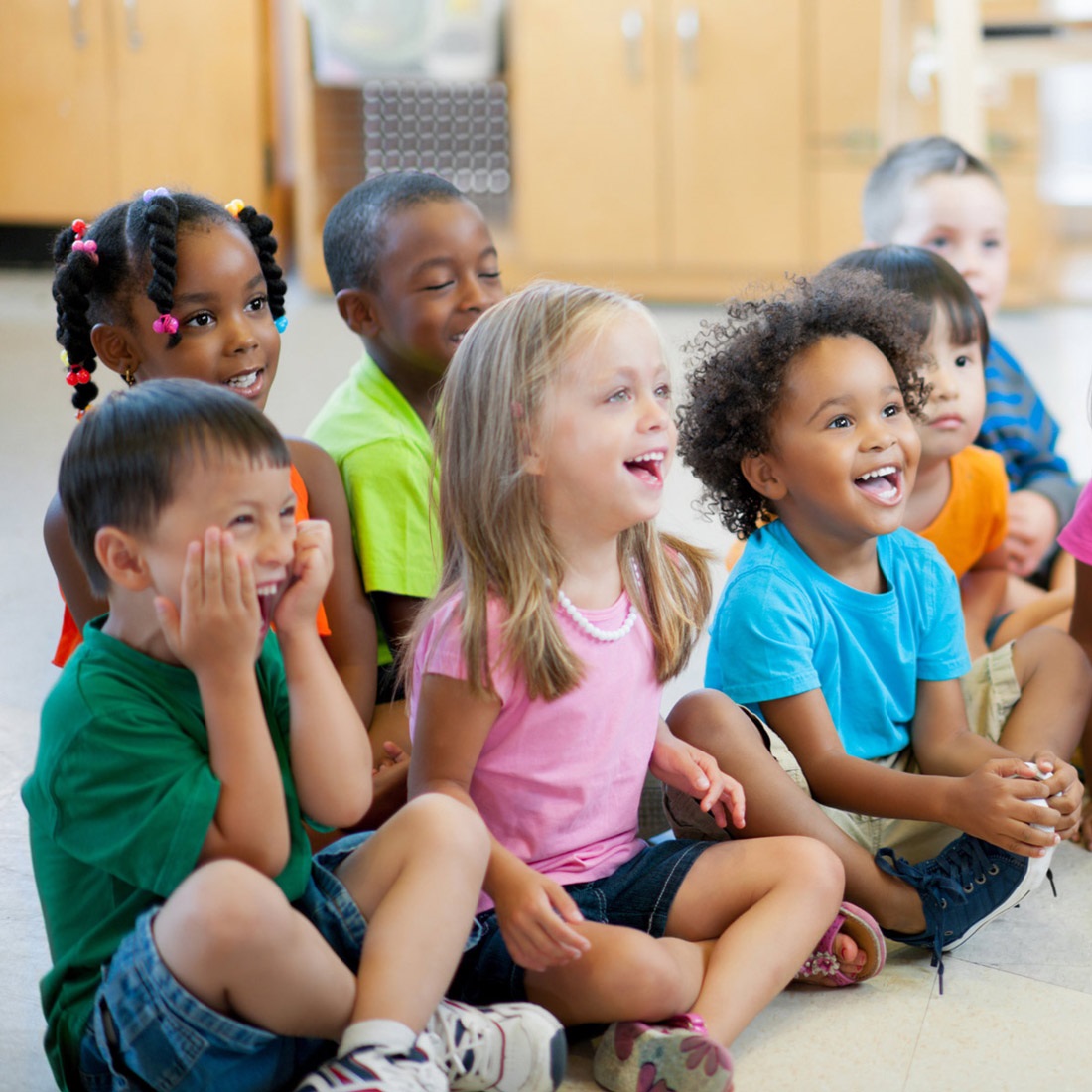 Excited children having a wonderful time listening at Summer Reading Storytime.