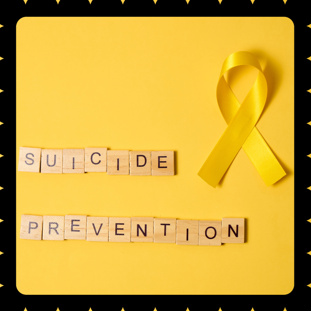 Image shows the words "Suicide prevention" written in scrabble letters on a yellow background with a black border.  On the right side there is a yellow ribbon.