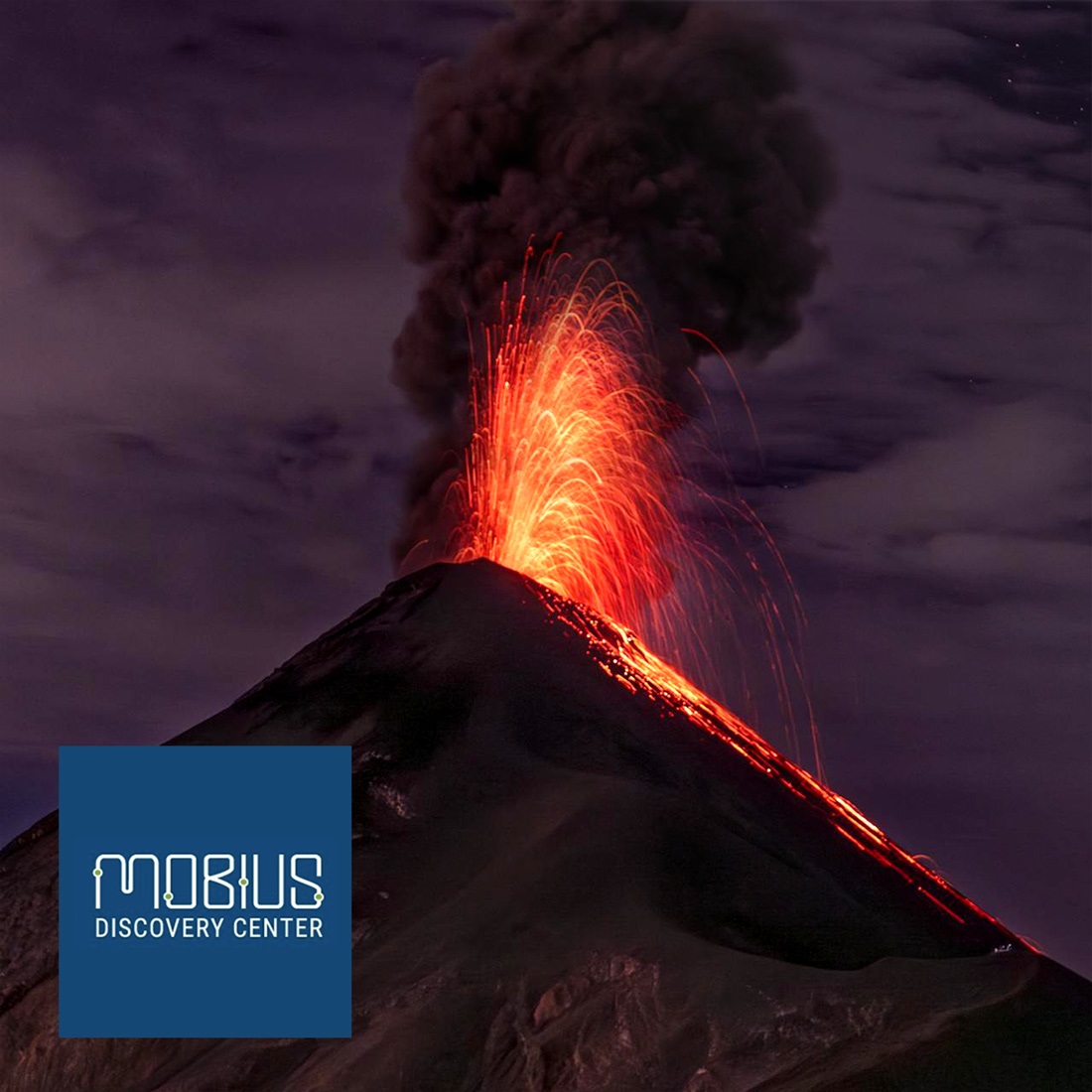 An actively erupting volcano and the Mobius logo.