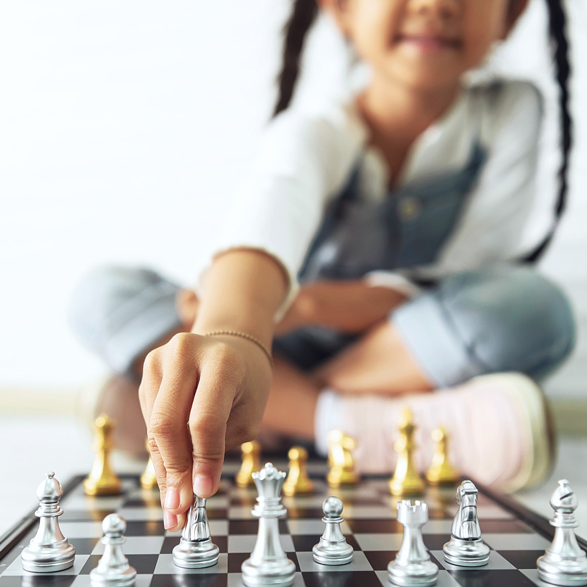 Young girl playing chess.