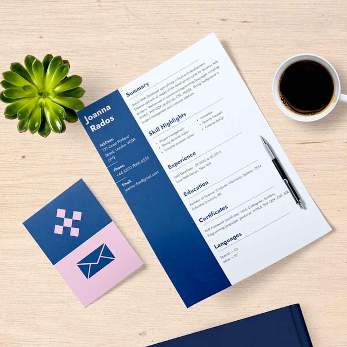Image shows a resume, a cup of coffee, and a green plant on a desk top.