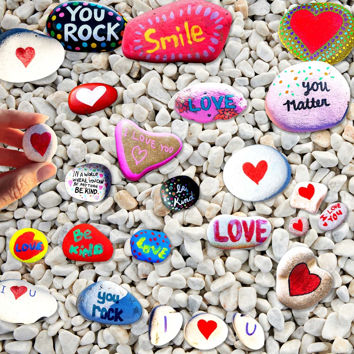 Several rocks painted with hearts or Valentine's messages such as, 