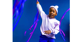 African American girl twirling a pink ribbon