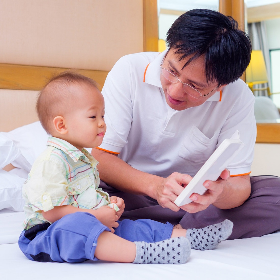 A dad reading to his baby boy who is loving being read to!