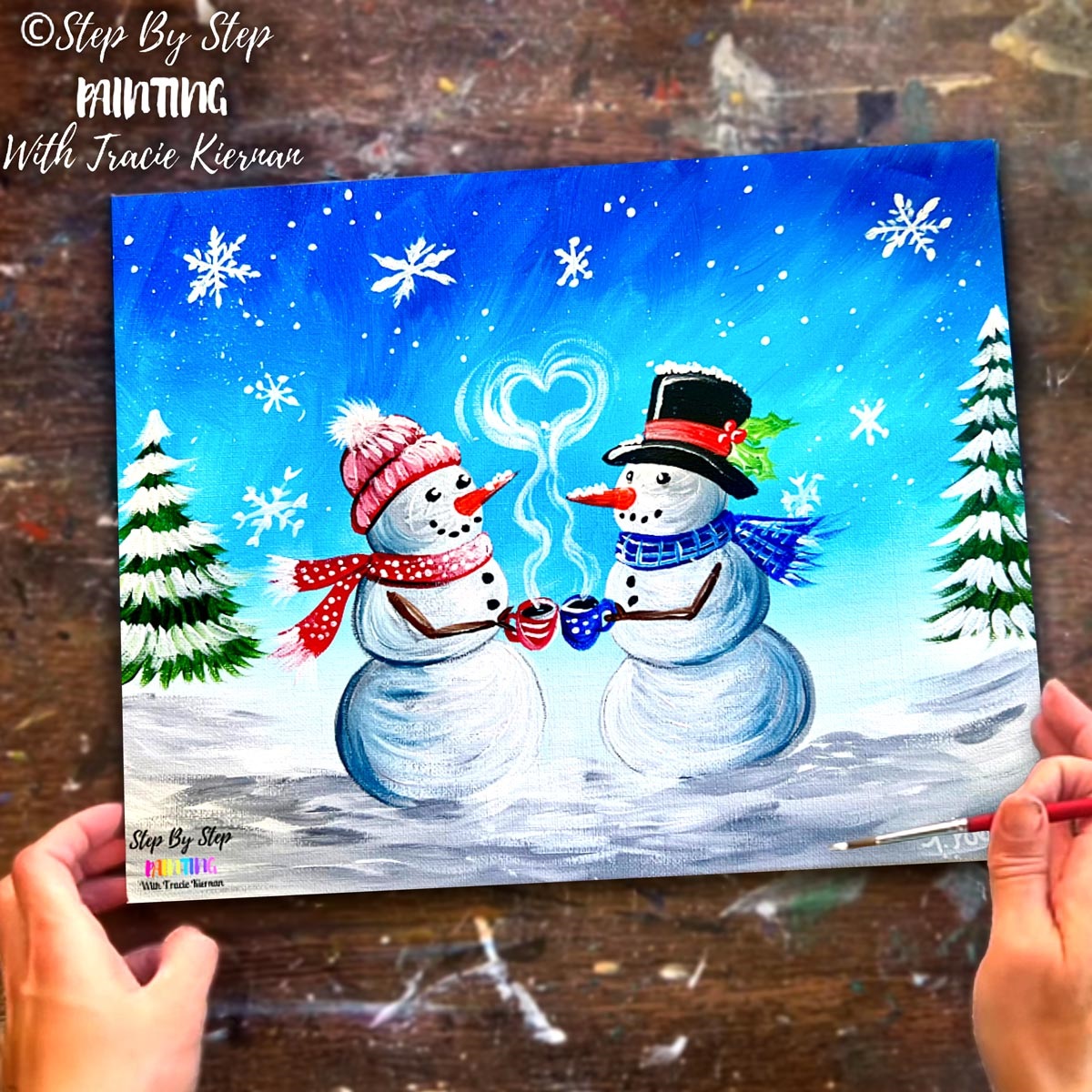 two snowmen in a field of snow