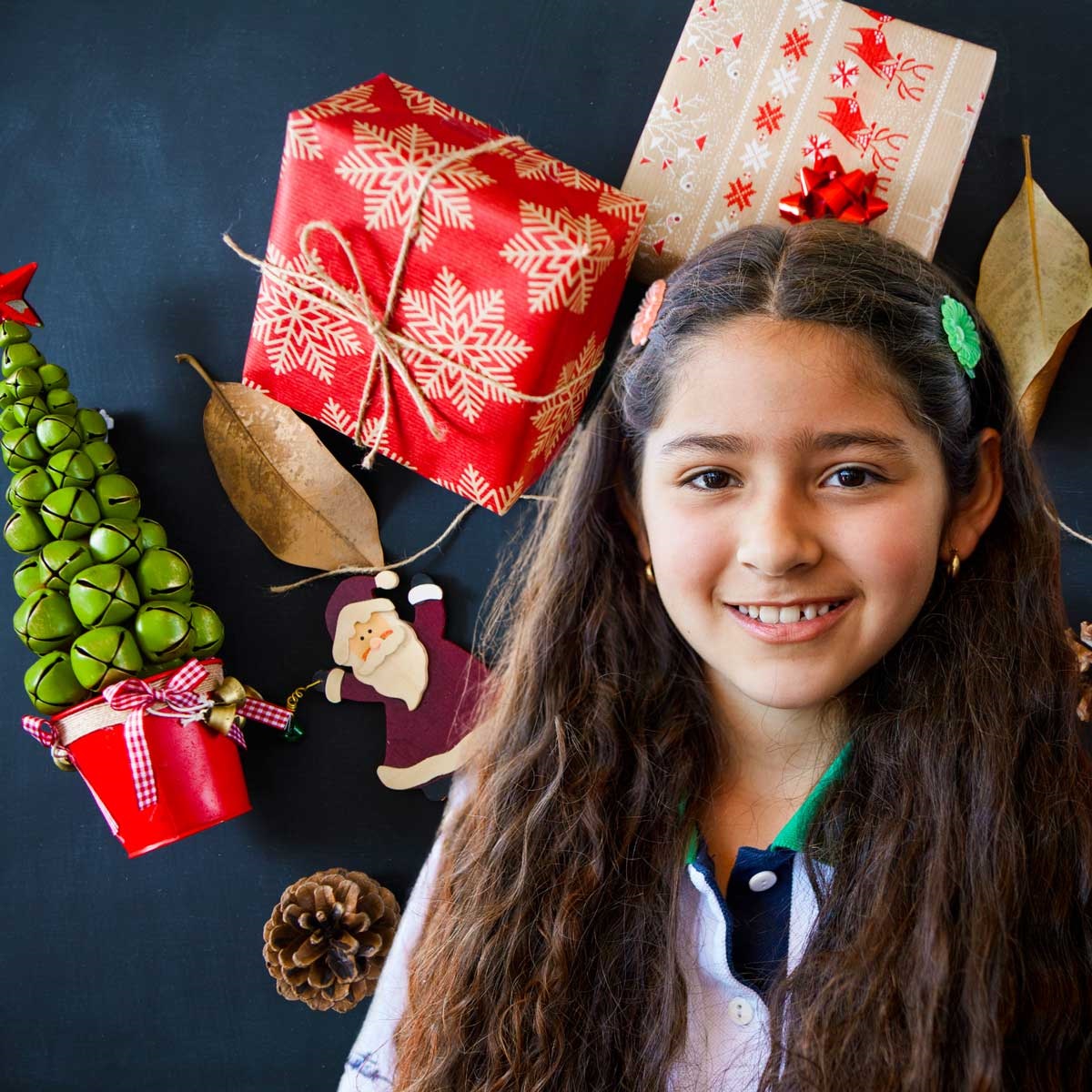 Tween girl smiling with Christmas presents in the background