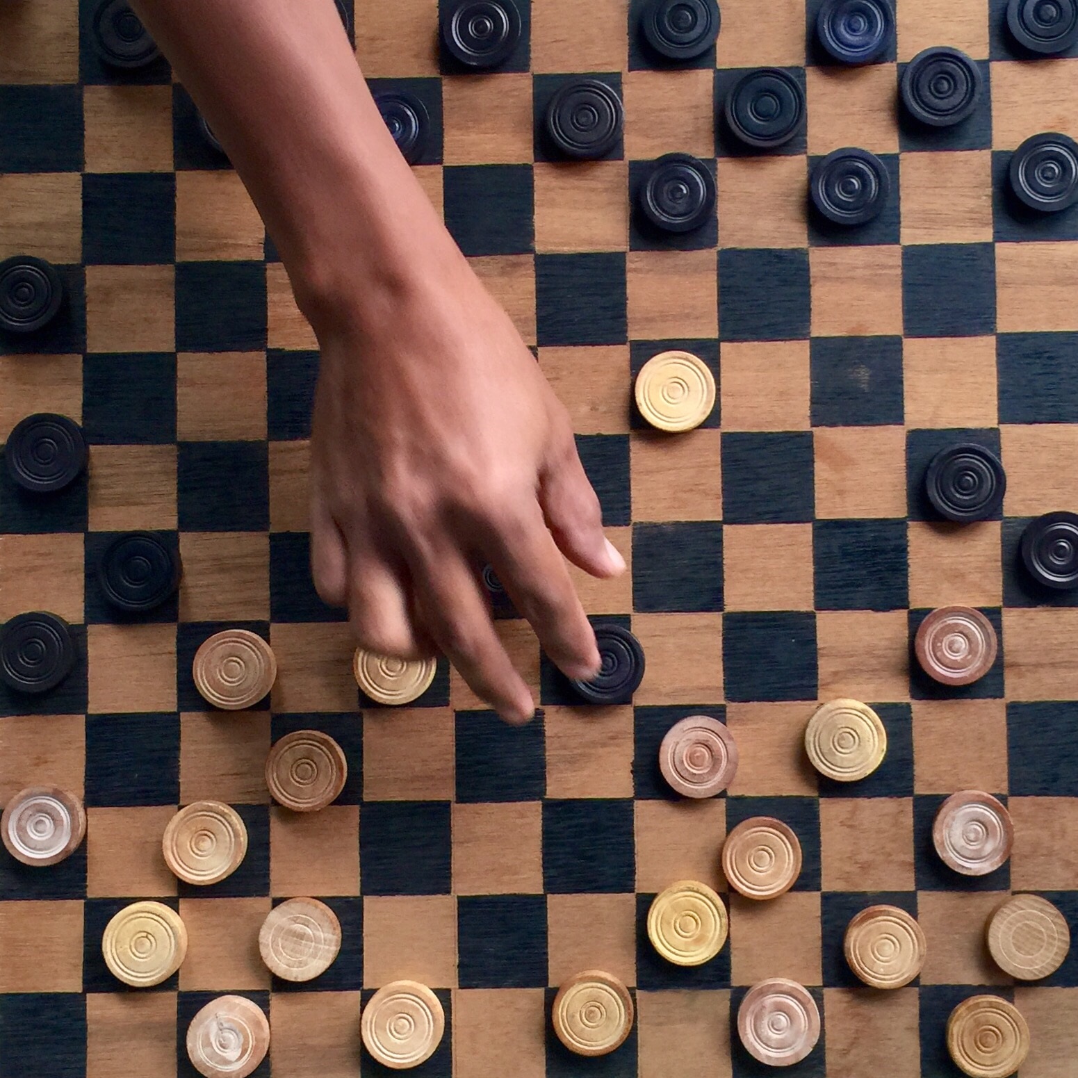 Chess board with a hand moving pieces