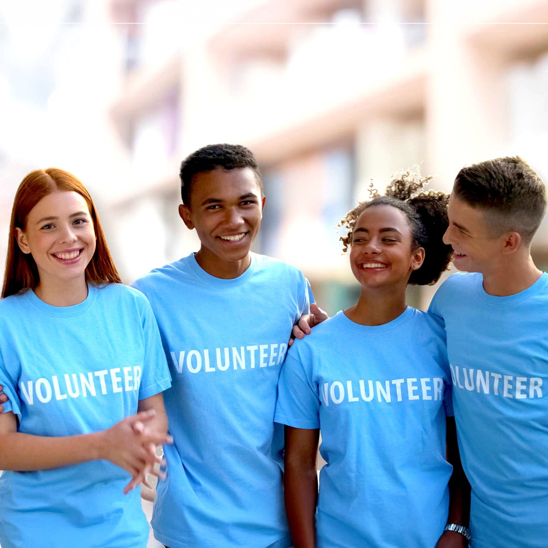 Teens wearing t-shirts that say volunteer. Link to external site, opens in new tab or window.