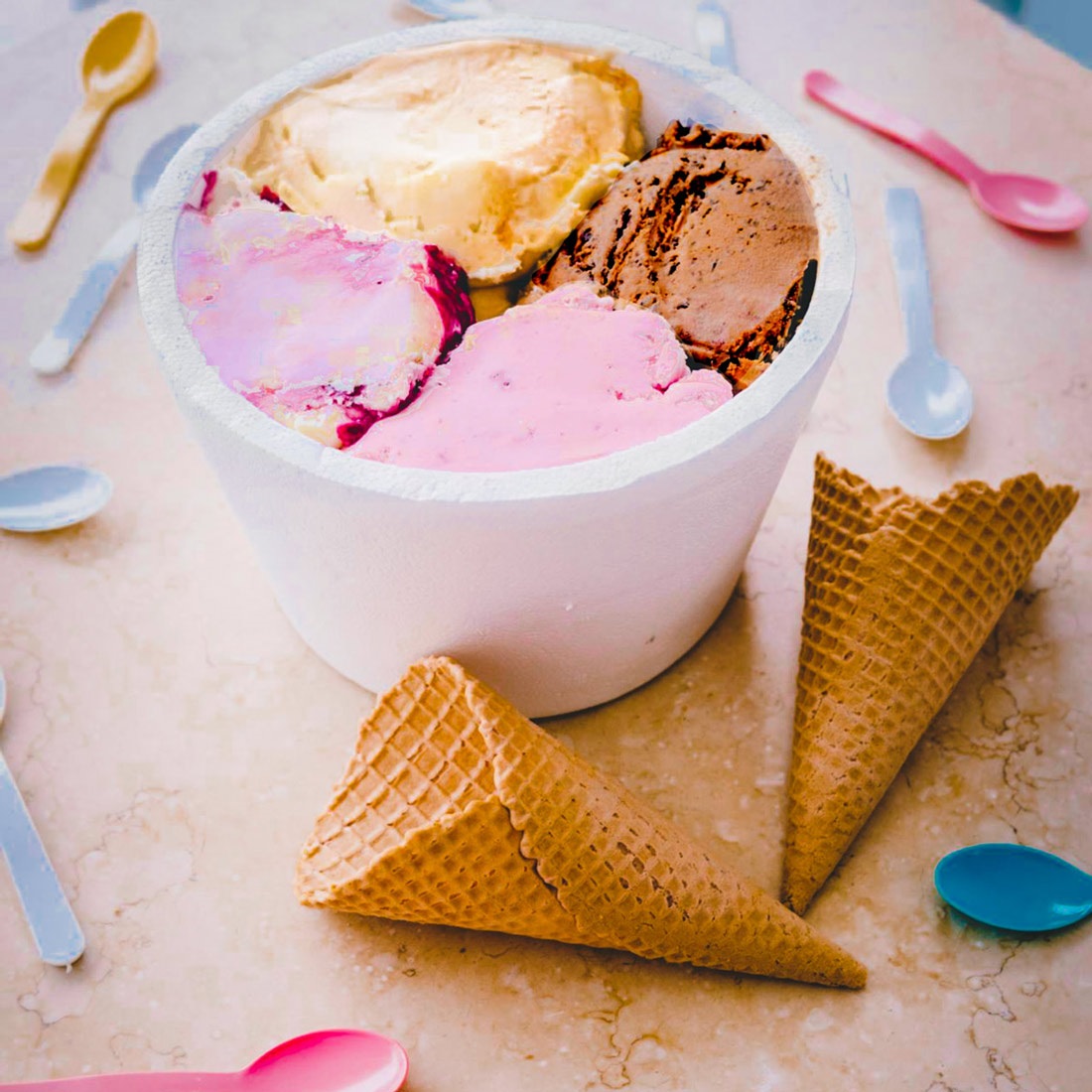 Strawberry, vanilla, and chocolate ice cream in a bowl at an ice cream party.