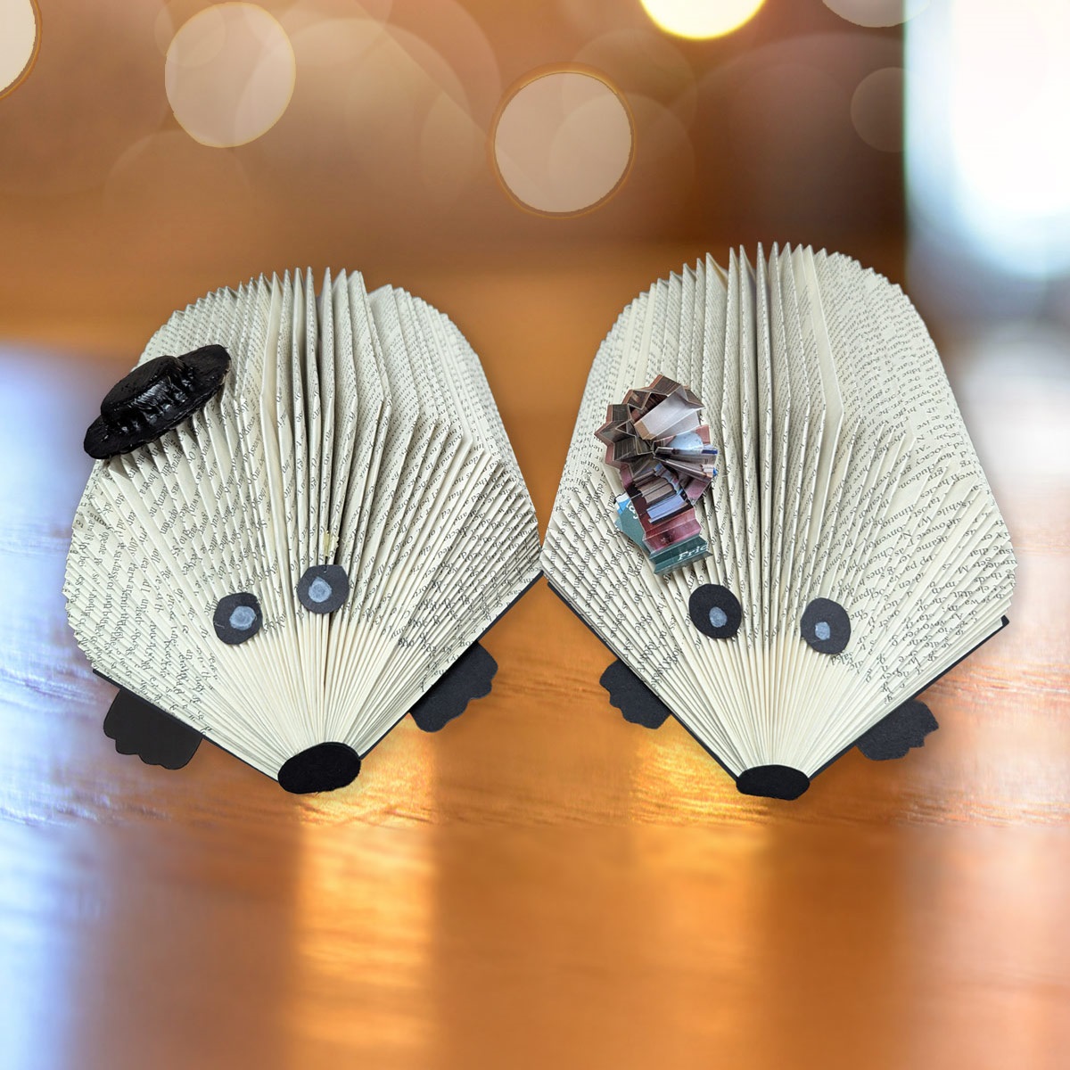 The pages of two books folded to make the books look like hedge hogs, sitting on a table in the library.