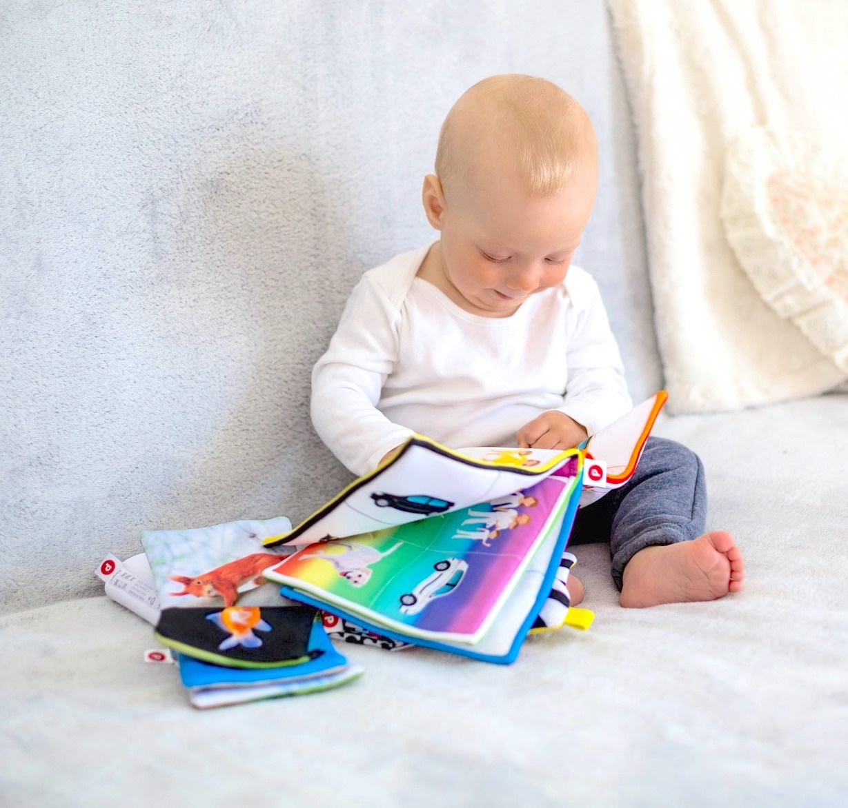 Baby sitting up reading a book