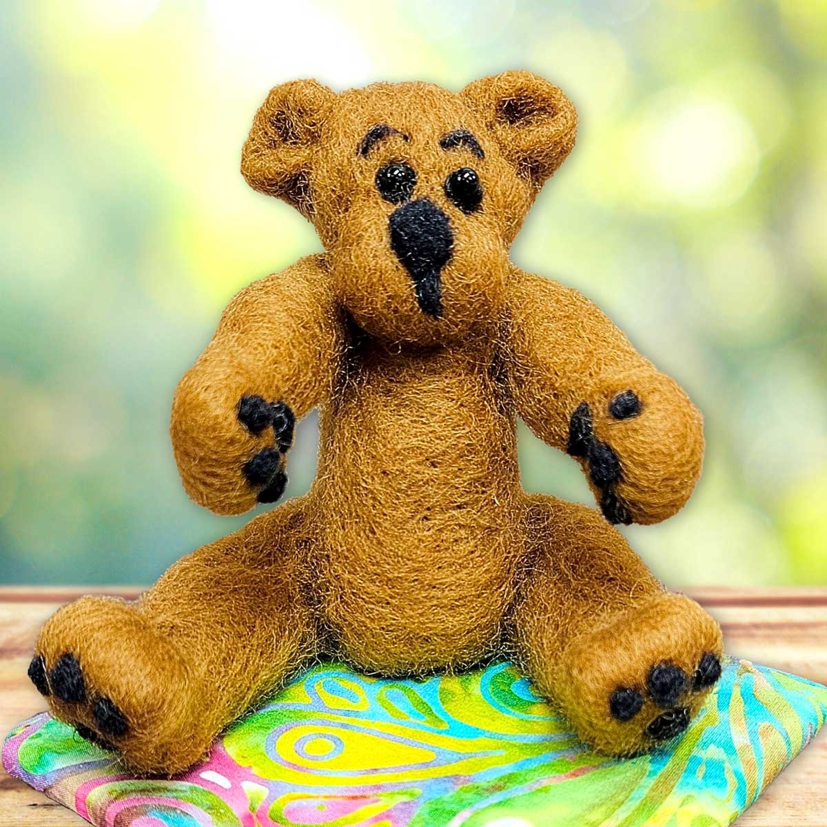 Image shows a brown and black needle felted bear. Links to external site that opens in a new tab or window.