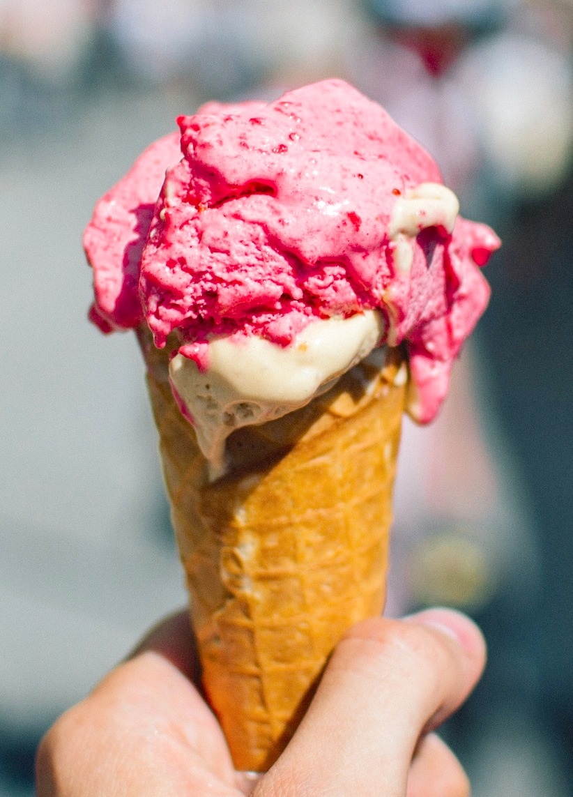 Hand holding a pink ice cream cone