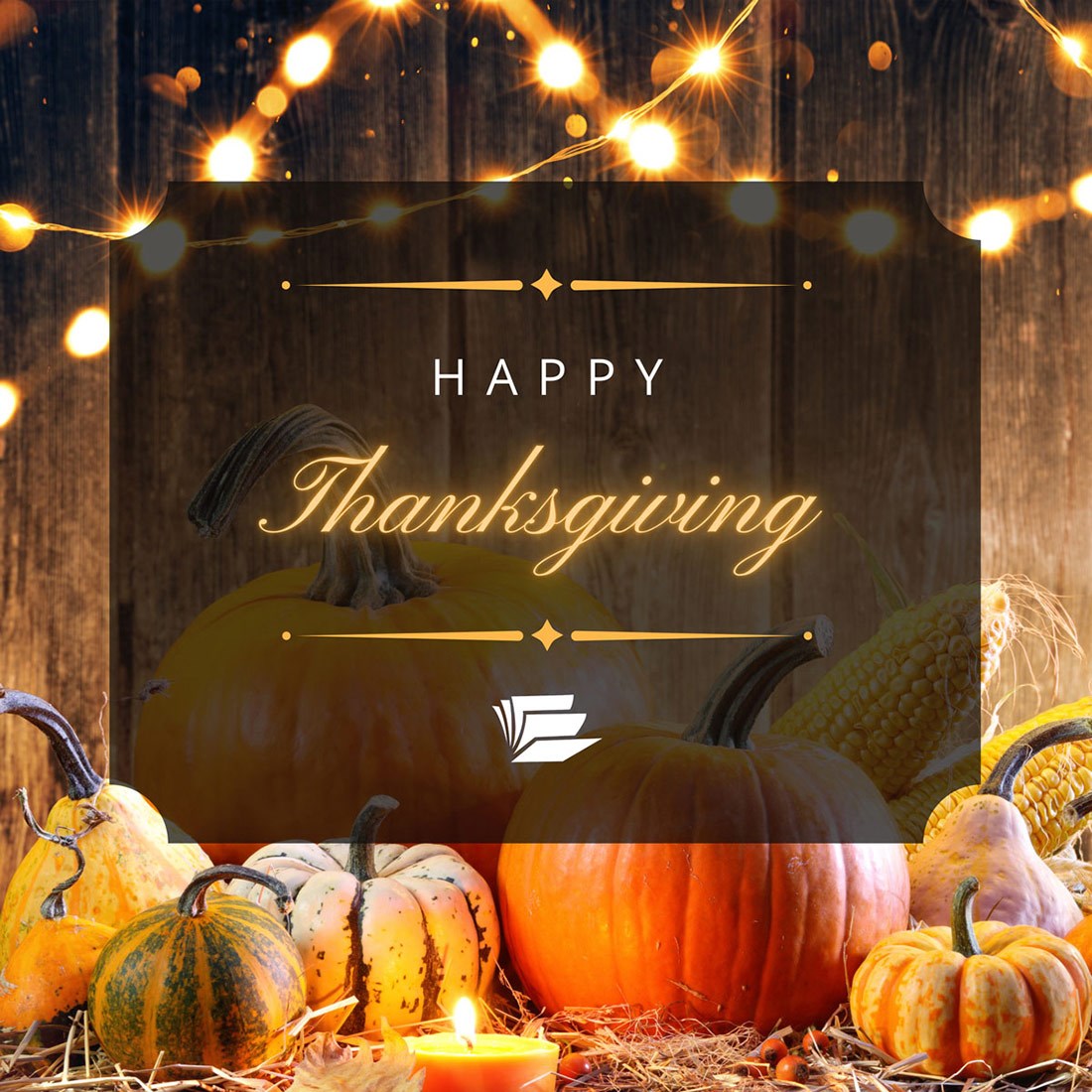 A book on a table, laid open with the center pages making a heart. Stacks of books flank either side with a library in the background. 